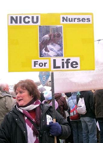 Woman with 'NICU Nurses for Life' sign