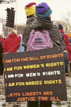 Activist at March for Life with sign proclaiming that 
'I Am For' the Bill of Rights, women's rights, men's rights, and babies' rights