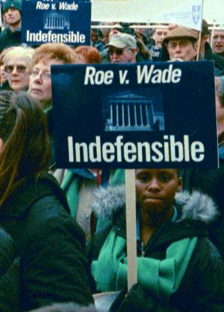 Demonstrators with signs: '<em>Roe v. Wade</em> Indefensible'