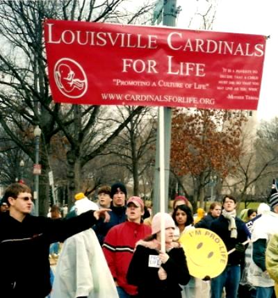 University of Louisville students with their red banner