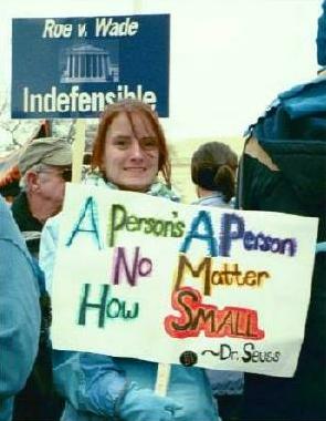 Woman with sign: 'A Person's a Person/No Matter How Small --Dr. Seuss'