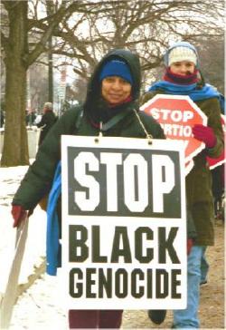 Woman at March for Life with sign: 
'Stop Black Genocide'